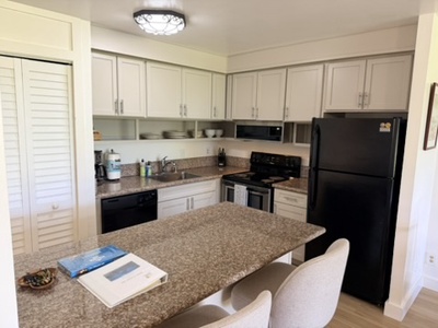 Step into your fully equipped kitchen with granite countertops, black appliances, and plenty of cabinet space to prepare your favorite vacation meals.