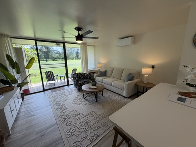 Bright, open living space with plush seating and climate control opens to a private outdoor area overlooking a tranquil garden—the perfect retreat after adventure.