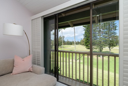 Sink into the plush seating and take in the sweeping views of lush green fairways framed by swaying palms and pines—your perfect spot to unwind with morning coffee or evening relaxation.