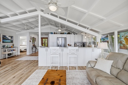 Relax in this airy, light-filled living space where vaulted ceilings and coastal breezes create your perfect island retreat. The open layout flows from lounge to kitchen, inviting you to settle in and unwind.
