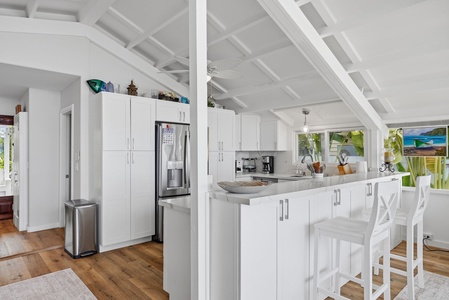 Bright, airy kitchen with modern appliances and island seating—your perfect spot for morning coffee or prepping island-inspired meals.