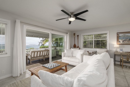 Sink into plush white sofas while ocean breezes flow through your sliding doors to a private balcony overlooking tropical paradise.