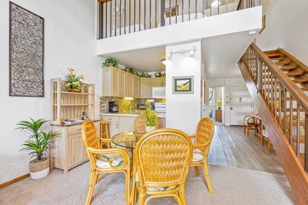 Relax in your bright, airy dining space with tropical touches and loft-style charm overlooking the fully equipped kitchen.