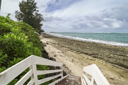 Step onto your private beach access from this secluded tropical paradise, where pristine sand meets crystal-clear waters.