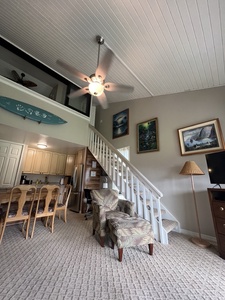Relax in your bright, open living space with soaring ceilings, cozy seating, and a fully equipped kitchen just steps away—perfect for unwinding after a day of adventure.