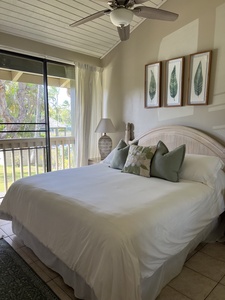 Sink into crisp white linens and feel the gentle breeze from your ceiling fan as natural light fills your tranquil bedroom retreat. Wake up to garden views and island breezes through your private balcony doors.