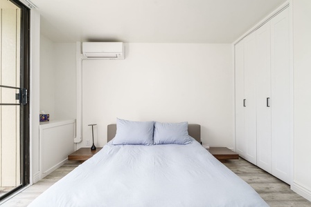 Unwind in your serene bedroom featuring crisp linens, climate control, and ample storage for a perfectly comfortable stay.