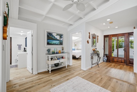 Step into your private retreat where coastal elegance meets island charm. Warm wood floors, vaulted ceilings with a gentle fan, and handpicked art create a welcoming atmosphere. Sunlight filters through the mahogany doors, inviting you to explore your pea