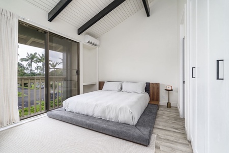 Drift off beneath exposed beams in your peaceful bedroom retreat, where crisp linens and tropical views create the perfect escape.