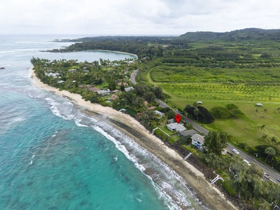 Stunning beachfront location with pristine turquoise waters and golden sand stretching along the lush tropical coastline.