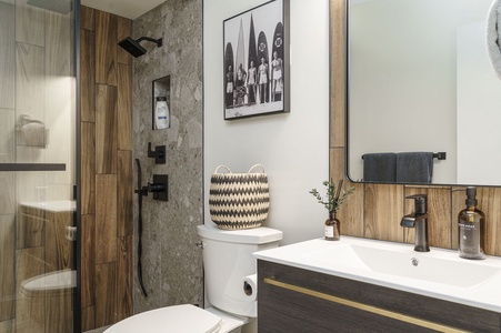 Relax in your stylishly appointed bathroom with modern fixtures and warm wood accents creating the perfect retreat.