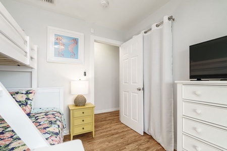 Your kids will love this cheerful bunk room with playful seahorse art and bright yellow nightstand for storing treasures.