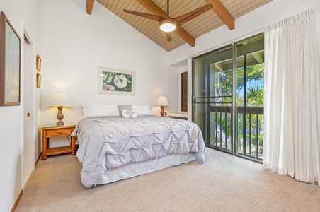 Wake up in your serene bedroom with exposed wood beams and sliding doors opening to tropical views beyond.