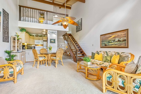 Your tropical retreat features soaring ceilings with exposed beams, cozy rattan seating, and an open loft that creates an airy, island-inspired atmosphere.