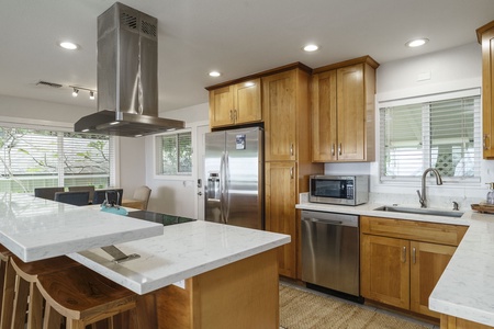 Cook effortlessly in your modern kitchen featuring sleek granite countertops, stainless steel appliances, and warm wood cabinetry.