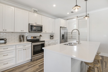 The well-stocked kitchen features light and bright finishes!