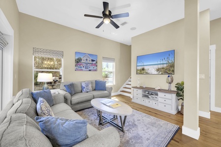 Sink into plush seating and unwind in your bright, coastal-inspired living room. Natural light pours through the windows, soft accents invite relaxation, and breezy beach vibes surround you—your perfect home base after a day exploring.