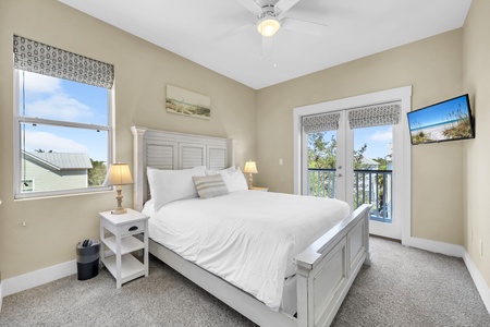 Wake up in your bright, coastal-inspired bedroom with a plush bed and warm natural light. Step through the French doors onto your private balcony and take in the fresh breeze—your perfect retreat awaits.