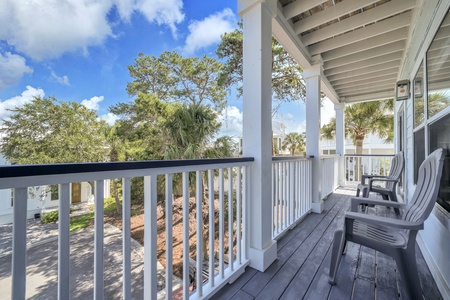 Settle into your favorite chair on this peaceful covered porch, where gentle breezes and leafy views help your vacation begin.