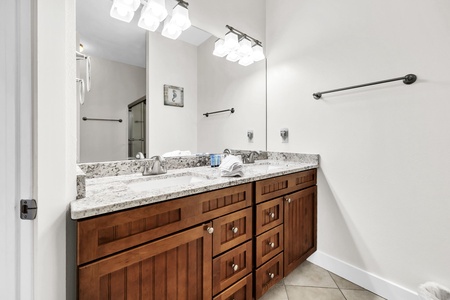 The 2nd floor guest bathroom, featuring a relaxing tub-shower combo and elegant rustic vanity with thoughtful touches.