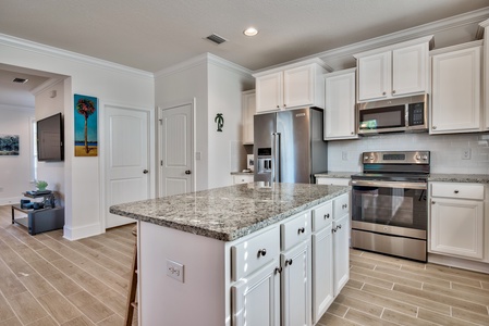 The kitchen island offers seating for three people!