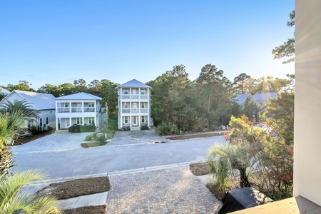 Peaceful residential neighborhood with coastal-style homes and mature landscaping near the property.