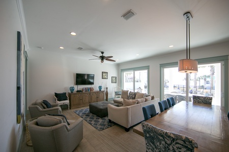 The spacious great room adjoins the dining-kitchen area, and offers views out to the pool deck!
