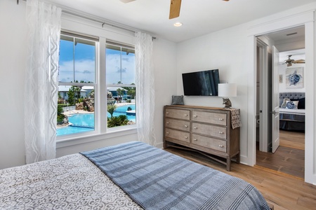 The first upstairs bedroom features a queen-bed and amazing pool views! features a queen-bed and amazing pool views!