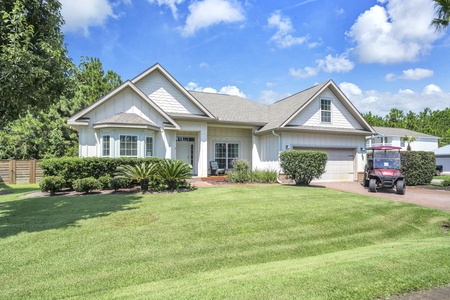This charming single-story home features pristine landscaping and a welcoming facade nestled in a peaceful residential neighborhood surrounded by lush greenery.