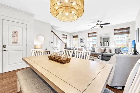 Gather around your spacious dining table for memorable meals, with a stunning chandelier overhead and bright living area flowing seamlessly together.