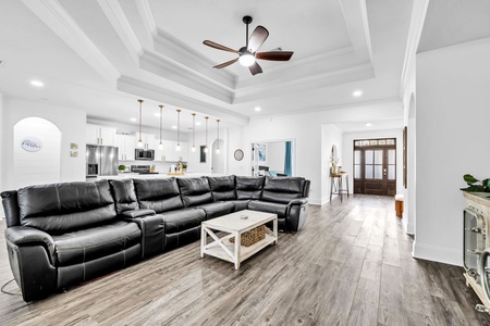 Stretch out on the spacious sectional and enjoy movie nights under soaring coffered ceilings with elegant pendant lighting.