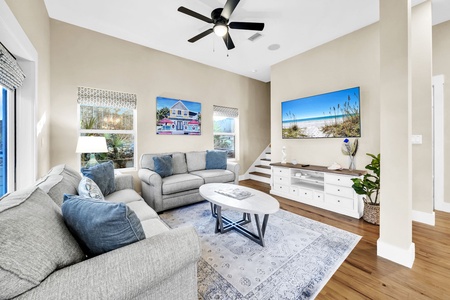 Sink into plush sofas in your coastal living room, where beach artwork and natural light create the perfect retreat.