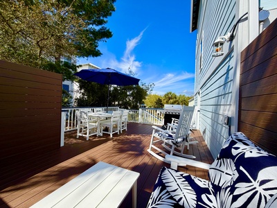 Step onto your private deck and breathe in the fresh air while relaxing in comfortable seating or dining al fresco under the blue umbrella.
