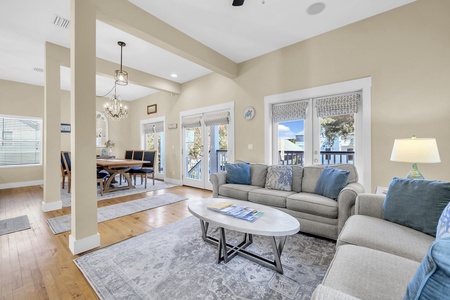 Sink into cozy sofas beneath soaring ceilings, where natural light pours through tall windows and an open layout invites you to relax and gather with loved ones.