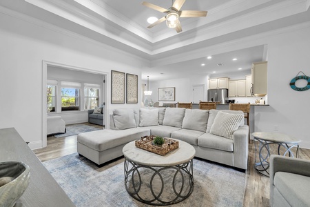 Unwind in your spacious living room where elegant ceiling beams meet plush seating, creating the perfect spot to relax after coastal adventures.