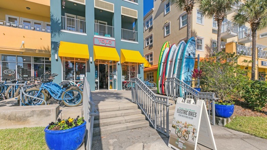 Colorful beachside shops and bike rentals create a vibrant local atmosphere steps from your vacation home.