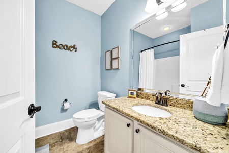 The guest bathroom is conveniently located at the center of the guest room hallway.