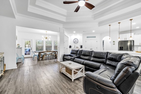 Relax on plush leather seating in this bright, open-concept space where modern comfort meets elegant design details.