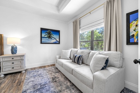 The master bedroom features a king size bed and a sofa for lounging (sofa sleeper not included).