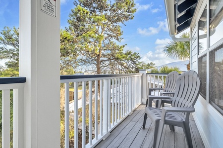 Step onto your private balcony and settle into comfortable chairs overlooking peaceful treetops and open skies—your perfect retreat spot.