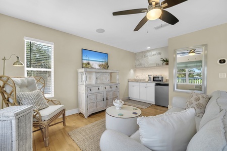 Settle into plush seating as a gentle ceiling fan keeps you cool in your bright, airy retreat. Your kitchenette and coastal décor invite laid-back mornings and effortless relaxation.