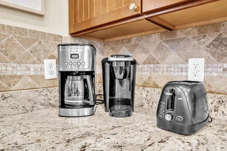 Start your mornings perfectly with premium coffee makers and toaster at your fingertips in this beautifully appointed kitchen.