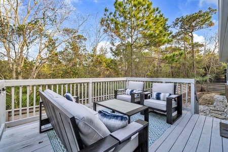 Your private deck overlooks peaceful treetops, where morning coffee and evening conversations feel perfectly at home in this serene outdoor retreat.