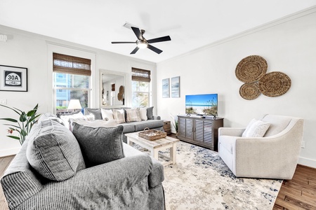 Sink into plush seating and unwind in your bright, beautifully designed living room with coastal touches and modern comfort.