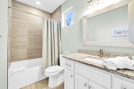 Guests in the ground floor queen bedroom will enjoy the adjacent full bathroom with tub-shower combo.