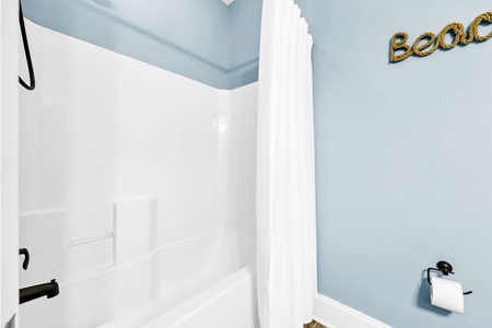 The guest bathroom includes a full-size shower-tub combo.