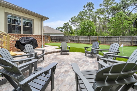 Your private backyard oasis awaits with a custom putting green, Adirondack seating, and a BBQ grill!!