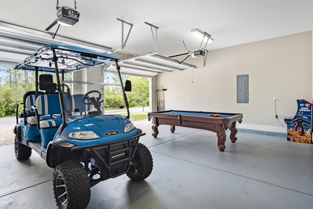 The garage game room area includes a full-size pool table and mini-arcade game!