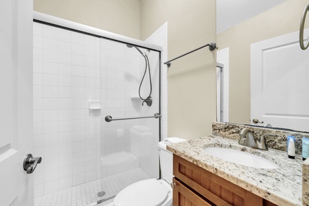 Your private bathroom features a spacious walk-in shower, granite countertops, and thoughtful grab bars for added safety and comfort during your stay.