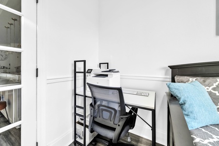 Your dedicated workspace features a sleek white desk and ergonomic chair, perfect for staying productive during your stay.